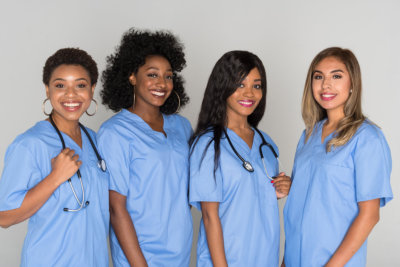 four nurses smiling